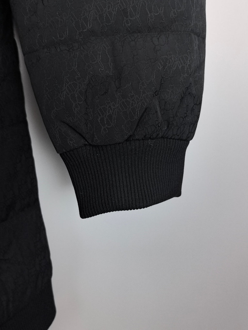 Prada puffer jacket sleeve with ribbed cuff and subtle allover texture