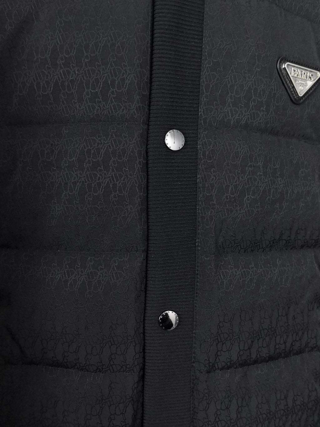 Prada puffer jacket front placket with snap buttons and textured knit panel