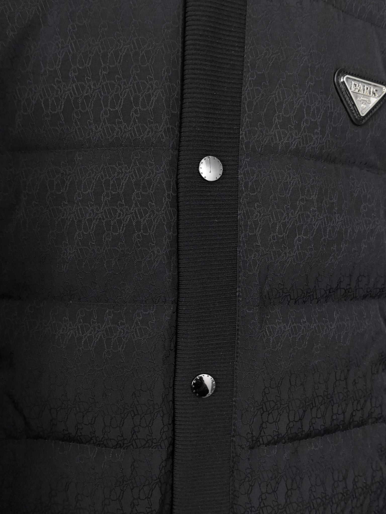 Prada puffer jacket front placket with snap buttons and textured knit panel