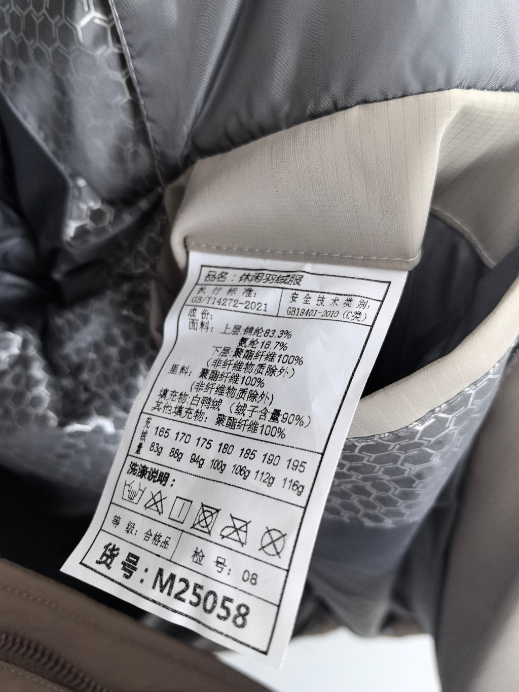Prada puffer jacket care label with sizing and fabric details