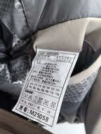 Prada puffer jacket care label with sizing and fabric details