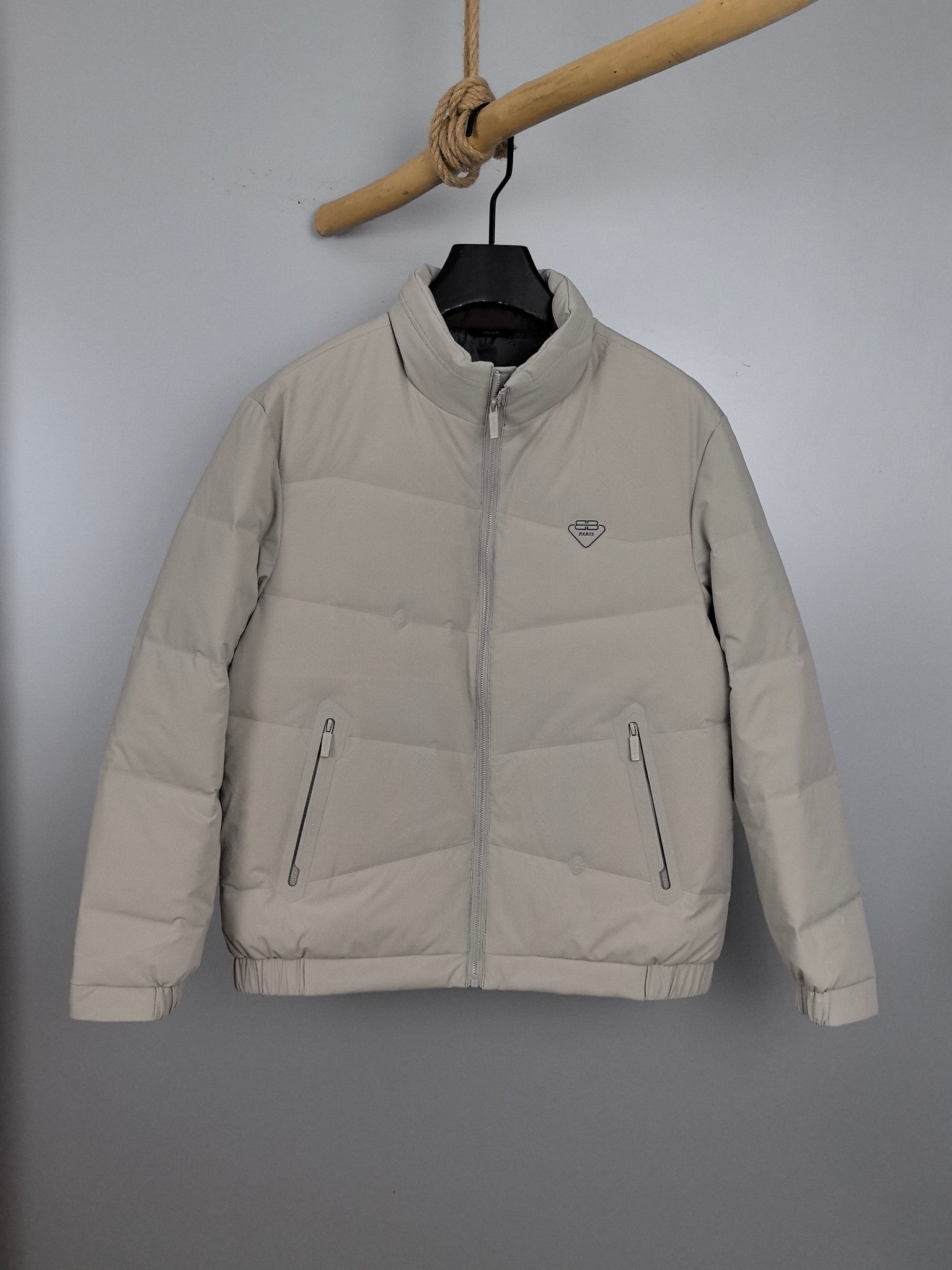 Light beige padded jacket with full-zip and stand collar, front view