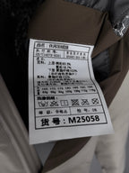 White care label on beige padded jacket with size and fabric information