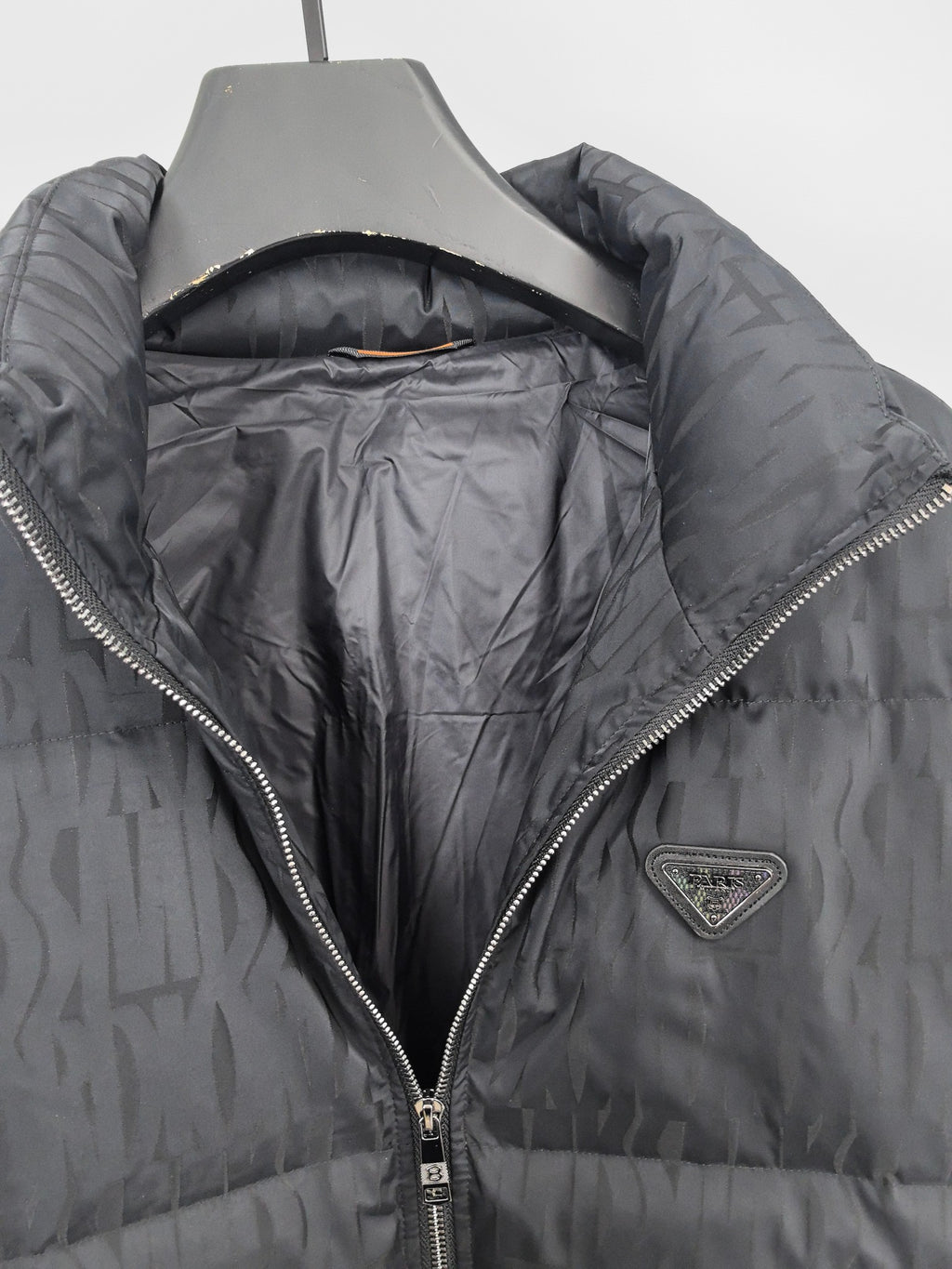 Prada puffer jacket open view showing dark interior lining and full front zipper