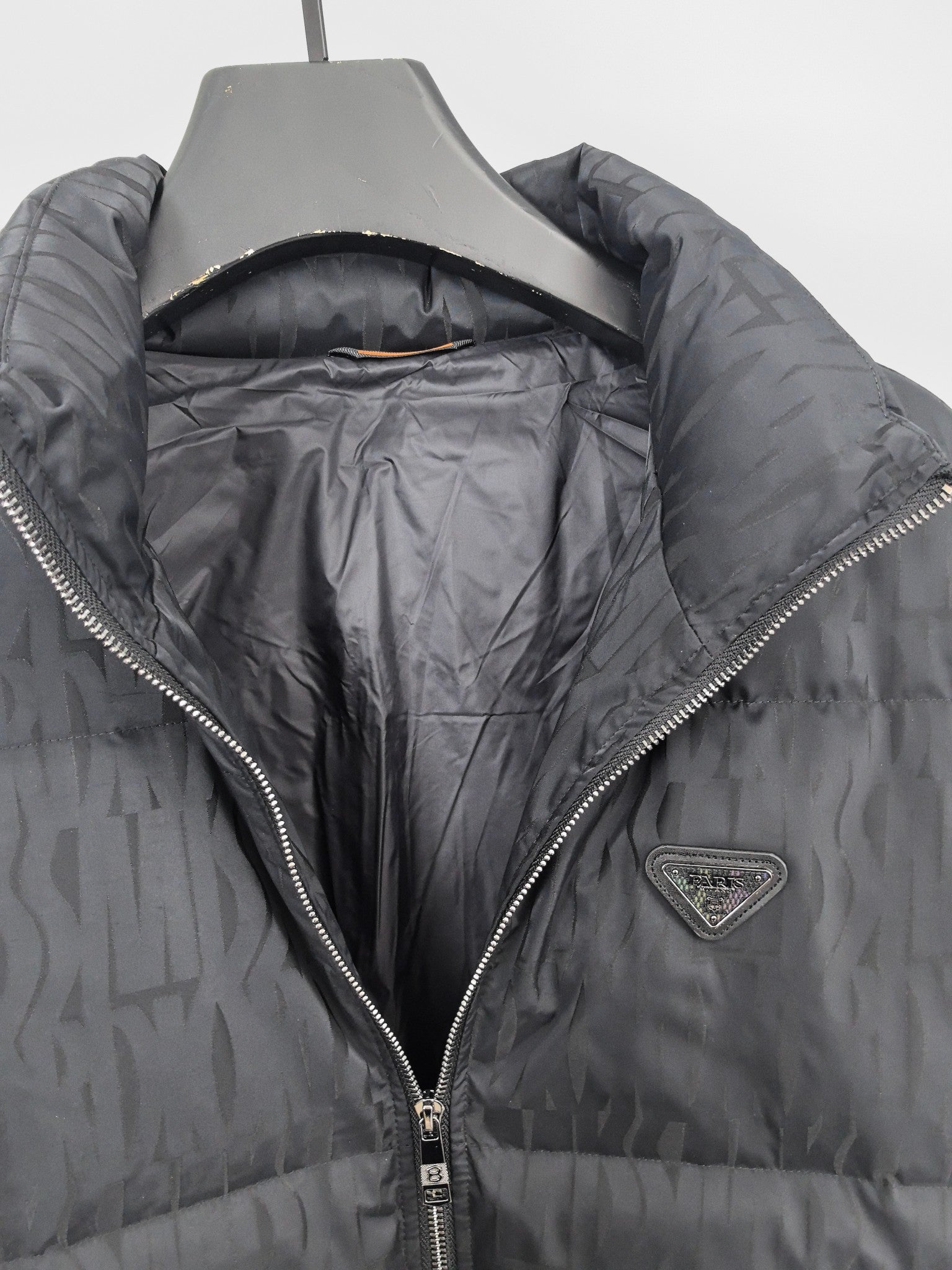 Prada puffer jacket open view showing dark interior lining and full front zipper