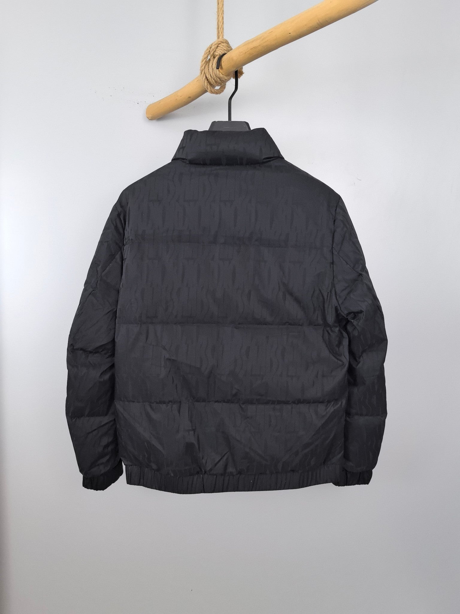 Prada dark quilted puffer jacket, back view with stand collar and full-length zipper