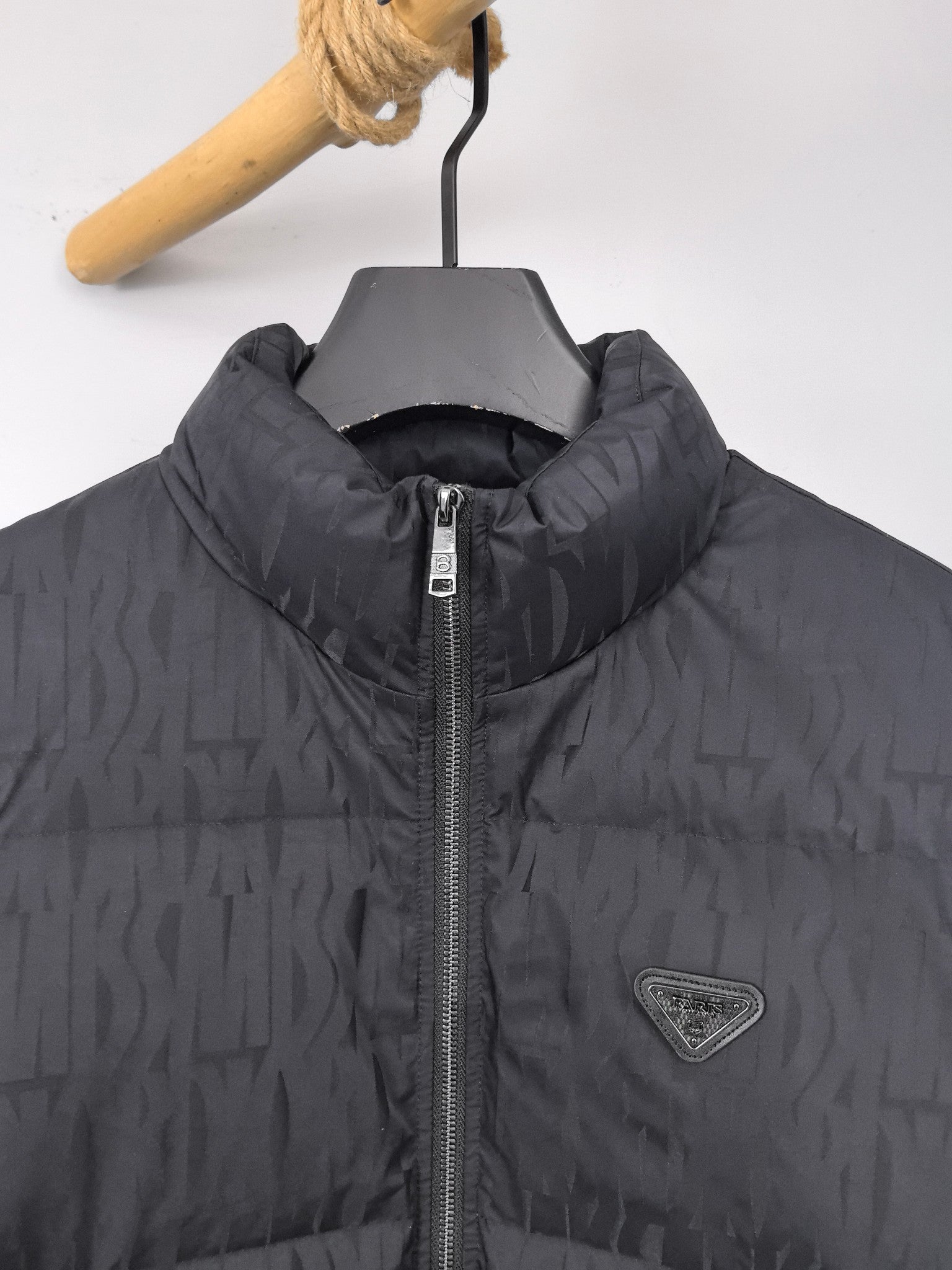 Prada puffer jacket detail: raised stand collar, full front zipper, logo patch on chest