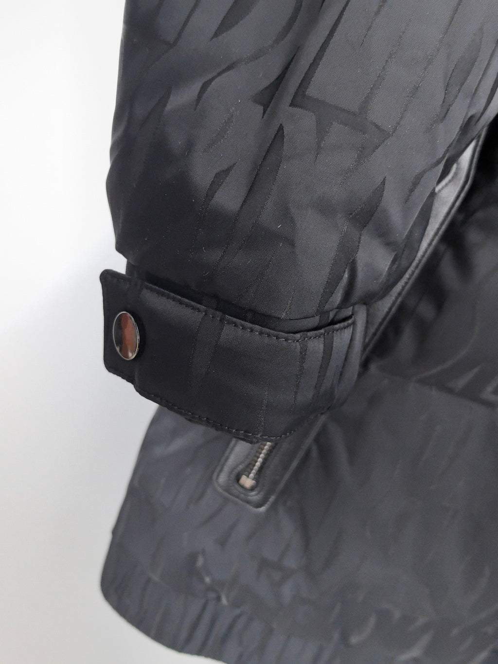 Prada puffer jacket sleeve cuff with snap tab and inner drawstring adjustment