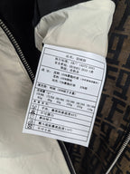 Burberry puffer jacket care label, size and material info on white tag