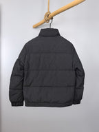 Long puffer jacket, black, back view with high collar and hood