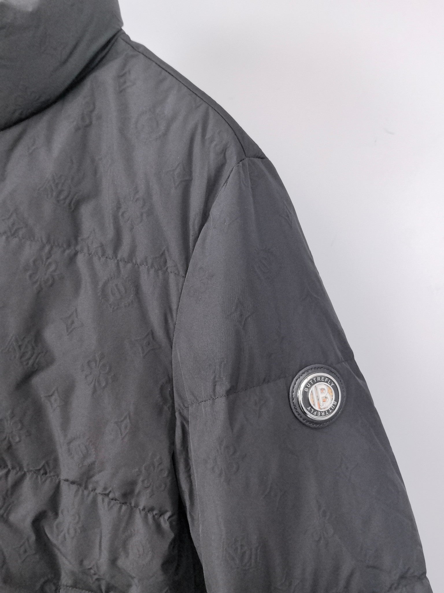 Long puffer jacket, black, side sleeve with circular logo patch