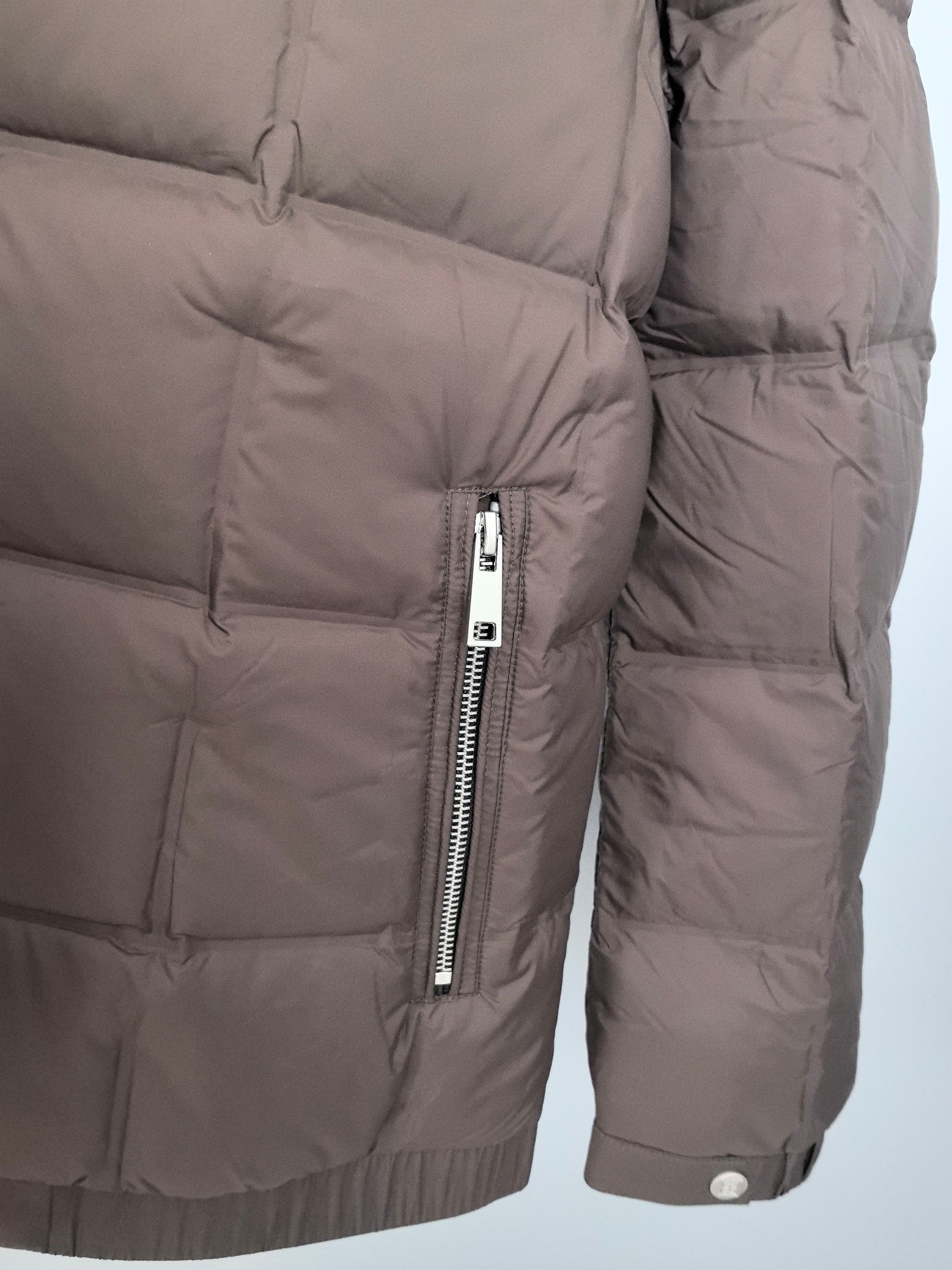 Brown puffer jacket side view with front zipper