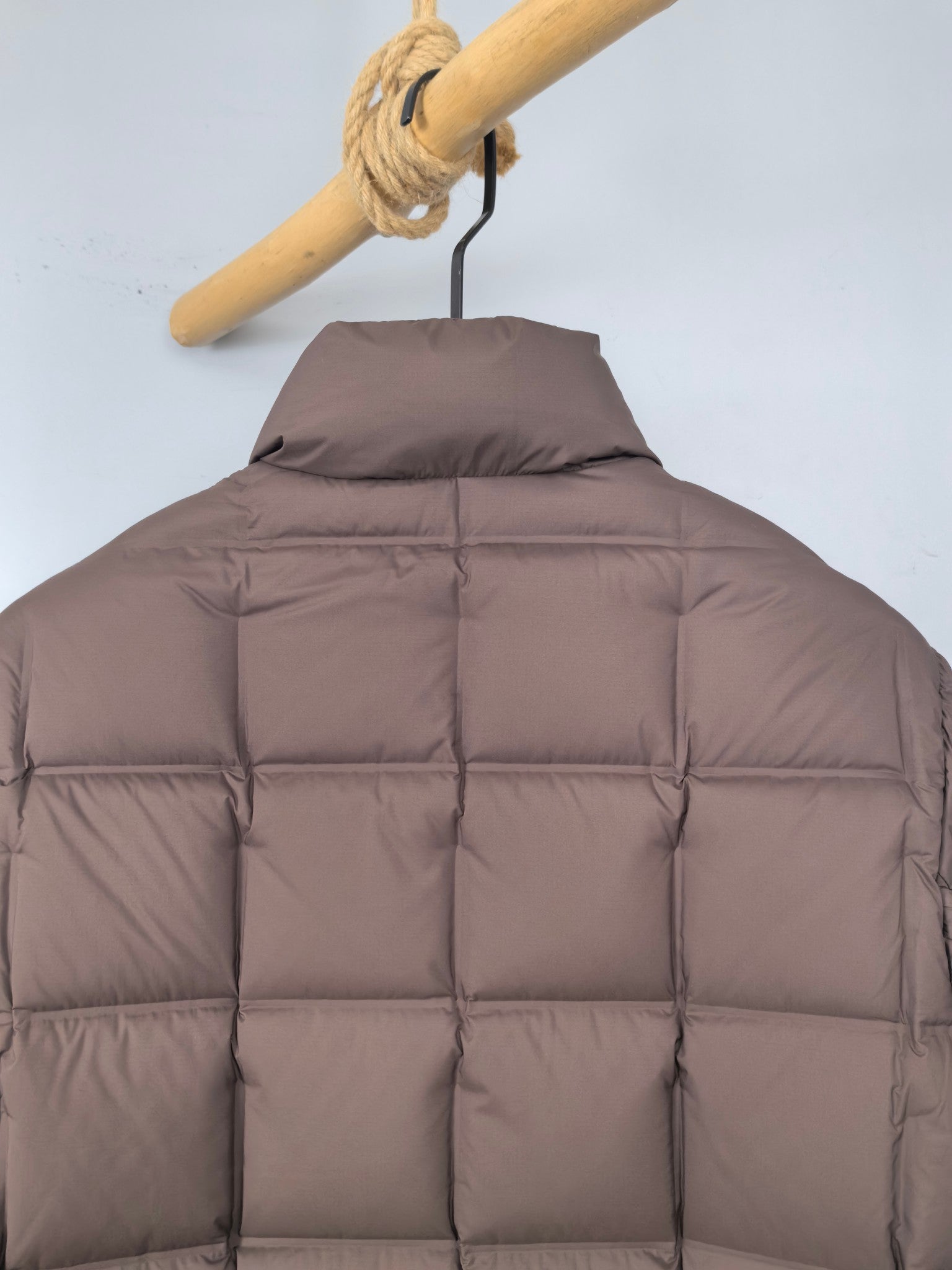 Brown puffer jacket back view with quilted yoke and horizontal seams