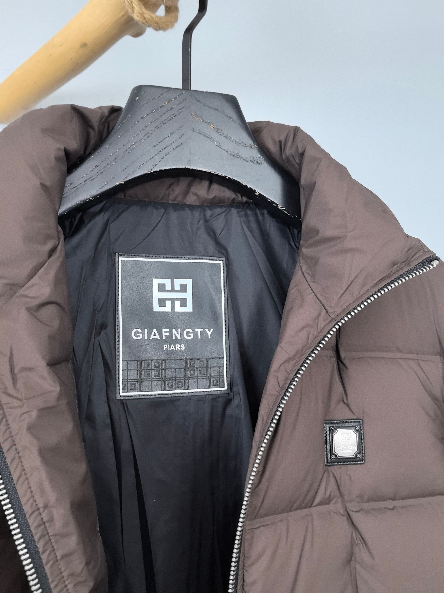 Brown puffer jacket lining with Givenchy logo label near chest pocket