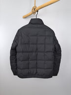 Black puffer jacket back view with padded quilted panels and full zipper