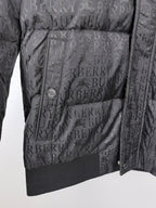 Long black puffer jacket front close-up with quilted panels and button placket