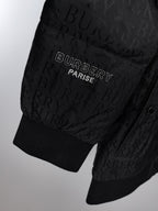 Long black puffer jacket sleeve hem with ribbed cuffs and logo embroidery