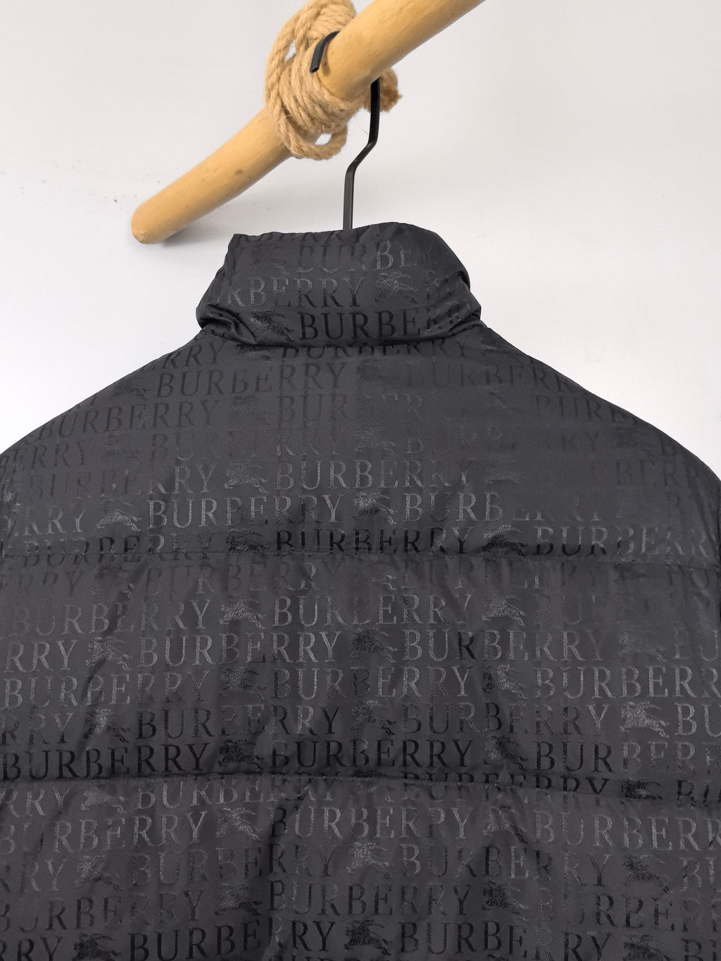 Long black puffer jacket back close-up with hood and raised collar