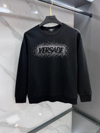 Black crewneck sweatshirt with rhinestone logo graphic on the chest