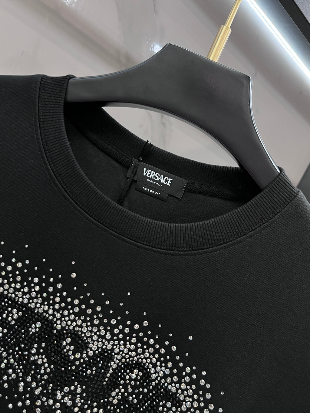 Versace sweatshirt neckline close-up, ribbed crew neck and logo label