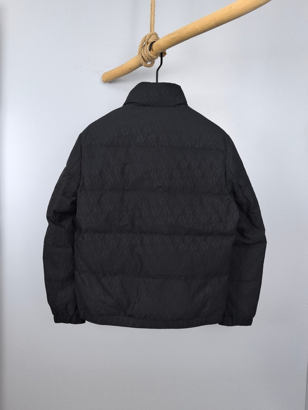 Black quilted puffer jacket, back view, full-length zipper