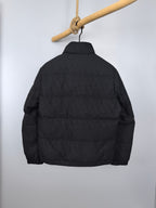 Black quilted puffer jacket, back view, full-length zipper