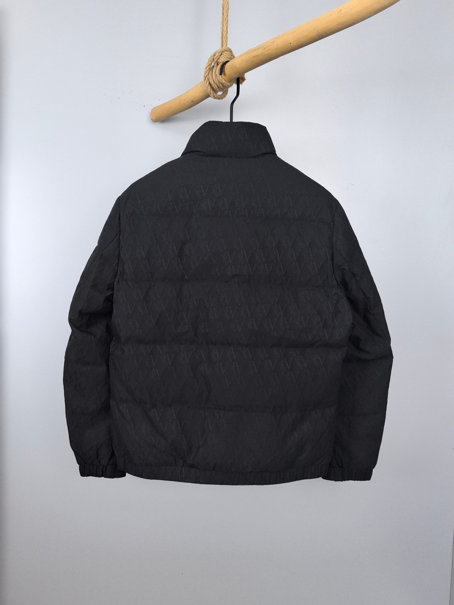 Black quilted puffer jacket, back view, full-length zipper