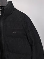 Black puffer jacket sleeve and chest panel with embroidered logo