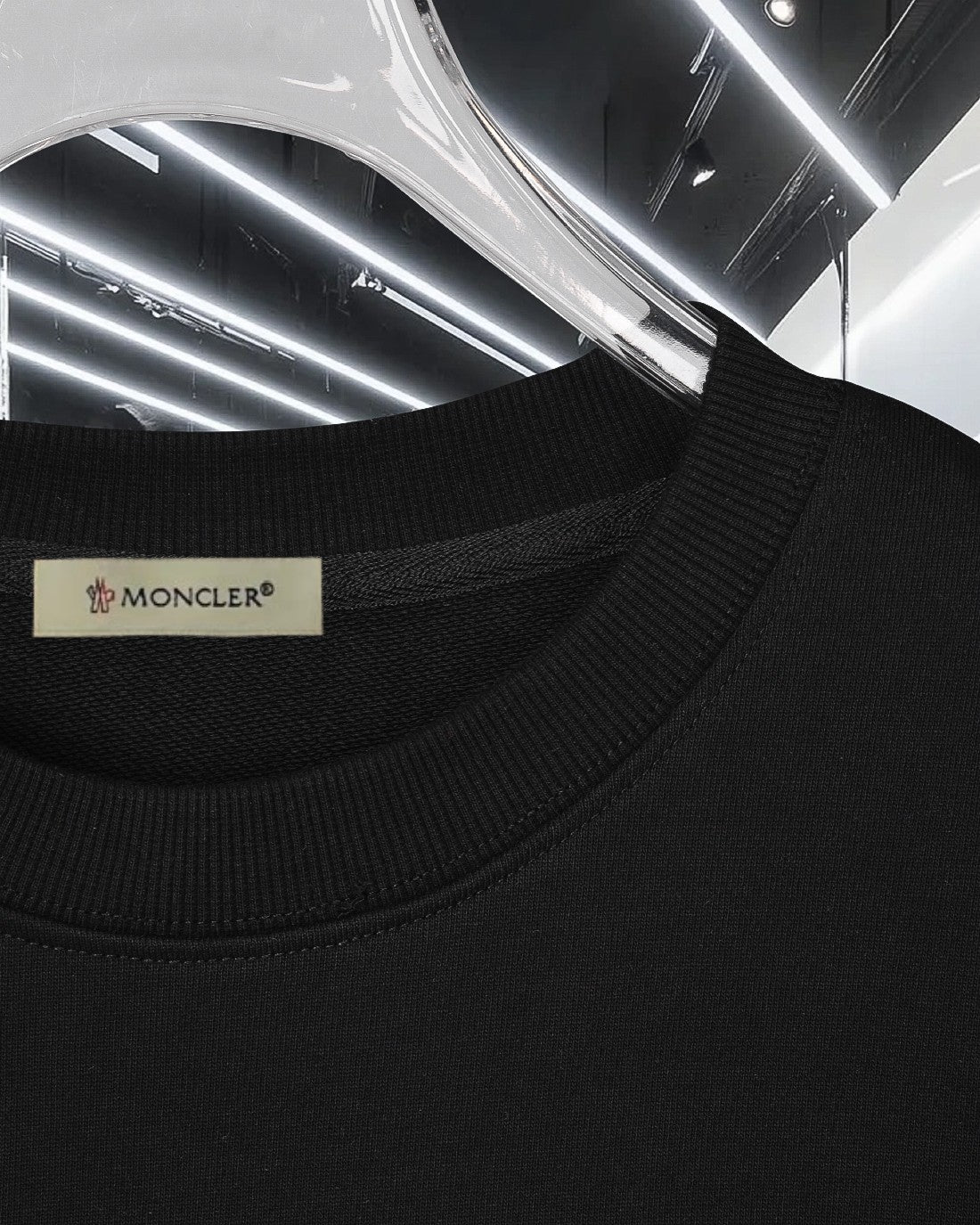 Moncler black crewneck sweatshirt with small brand label at neckline