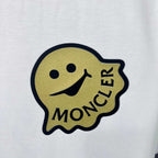 Moncler smiley face chest patch logo on white sweatshirt fabric