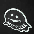 Moncler logo patch with white outline on dark fabric
