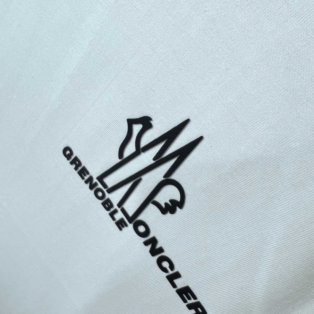 Moncler Grenoble logo graphic on white sweatshirt fabric