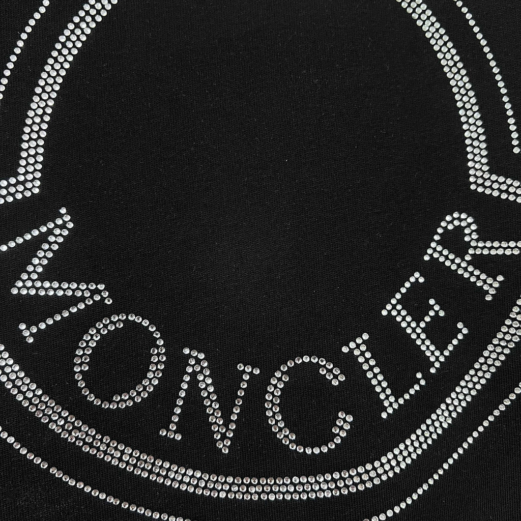 Close-up of rhinestone Moncler lettering on a black sweatshirt logo