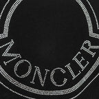 Close-up of rhinestone Moncler lettering on a black sweatshirt logo