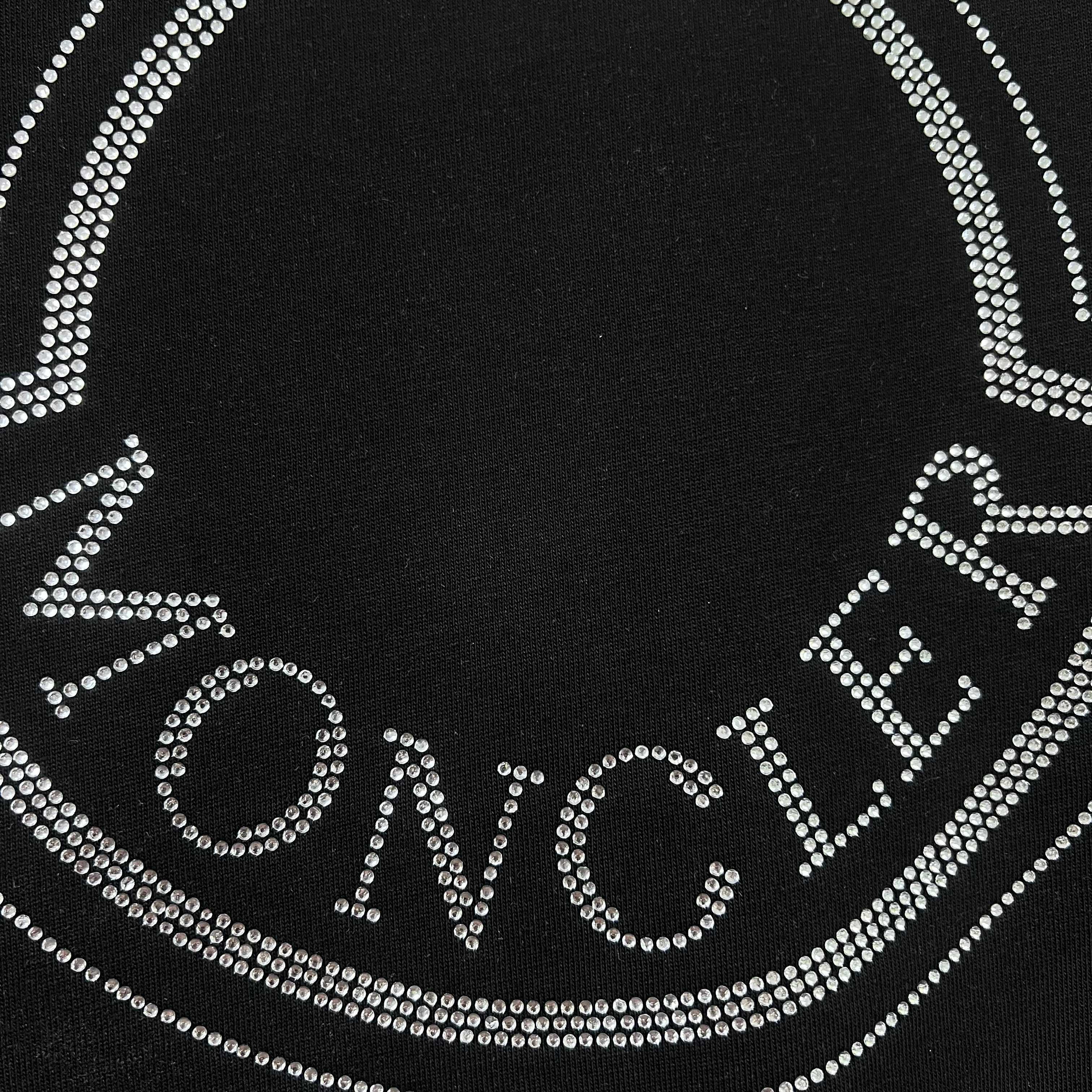Close-up of rhinestone Moncler lettering on a black sweatshirt logo