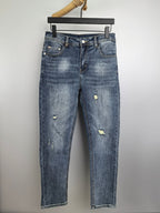 Denim pants with light wash and distressed patches, straight leg