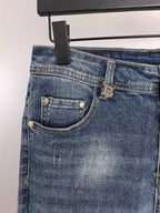 Denim pants back pocket close-up with stitched seams and metal rivet