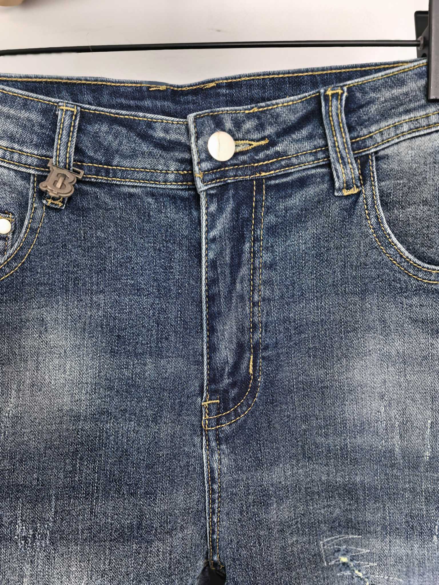 Denim pants waistband close-up with belt loops and button-front closure