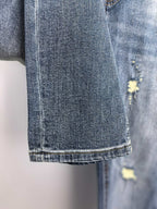 Denim pants hem and side leg with distressed yellow patch detail