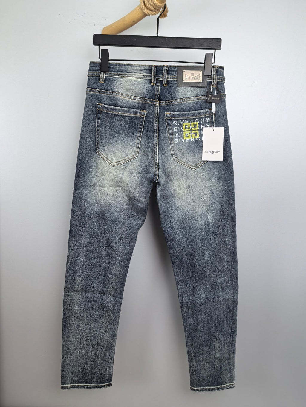 Givenchy blue denim jeans, back view with brand patch and paper tag