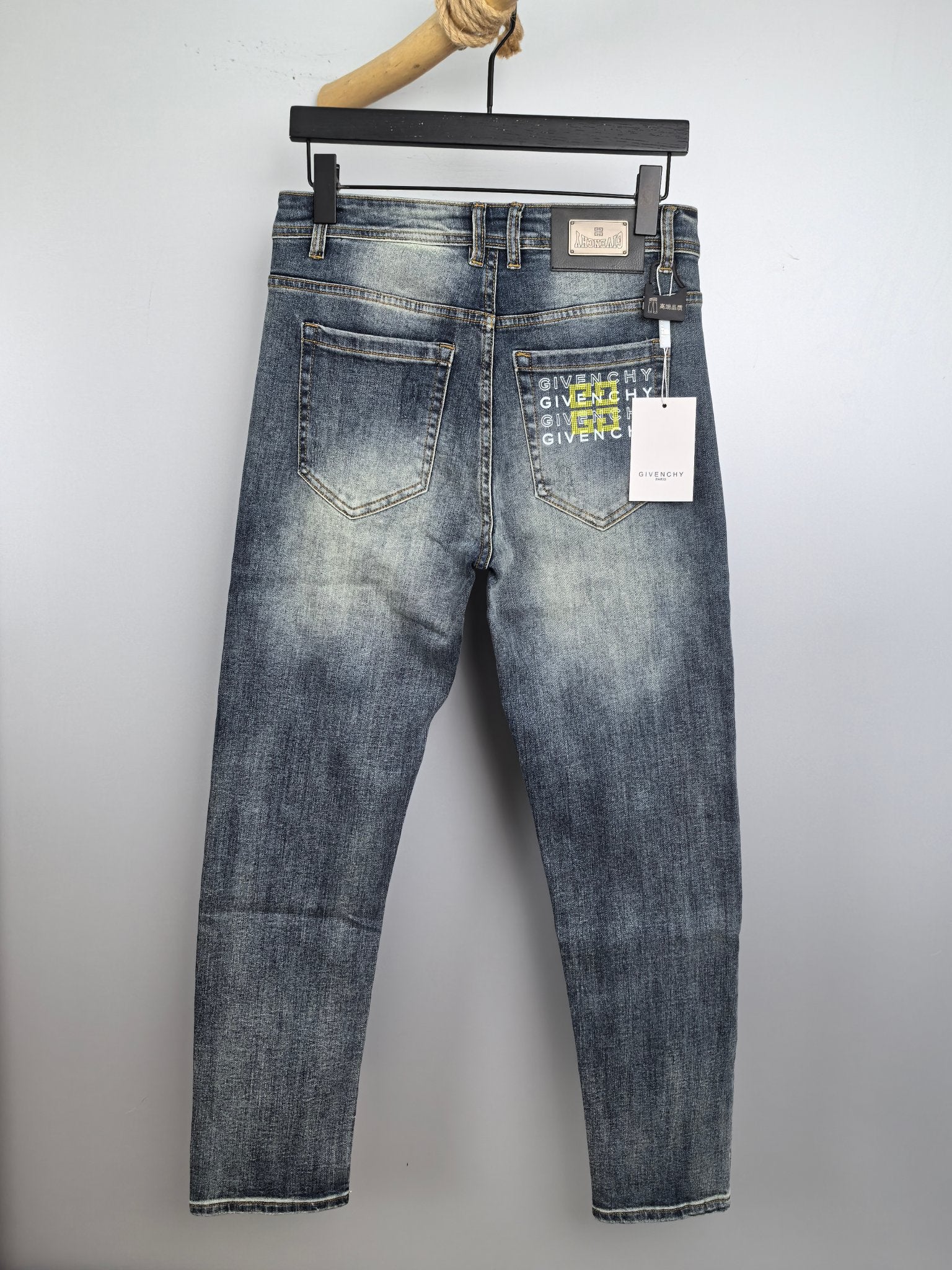 Givenchy blue denim jeans, back view with brand patch and paper tag