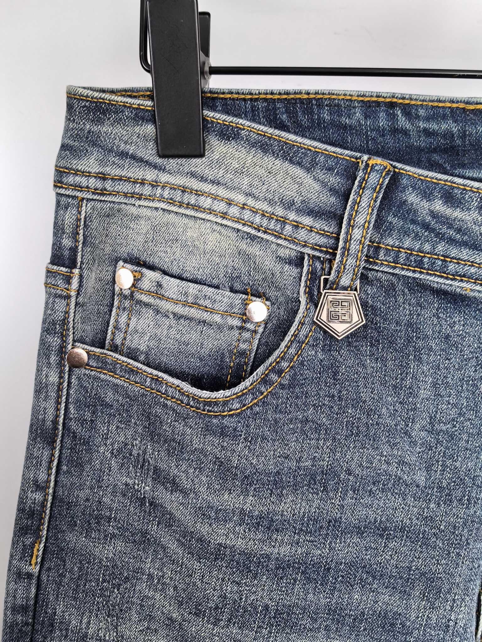 Givenchy denim jeans close-up of front pocket and stitched logo patch