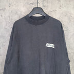 Balenciaga long-sleeve top closeup, dark charcoal gray, BALENCIAGA chest logo patch