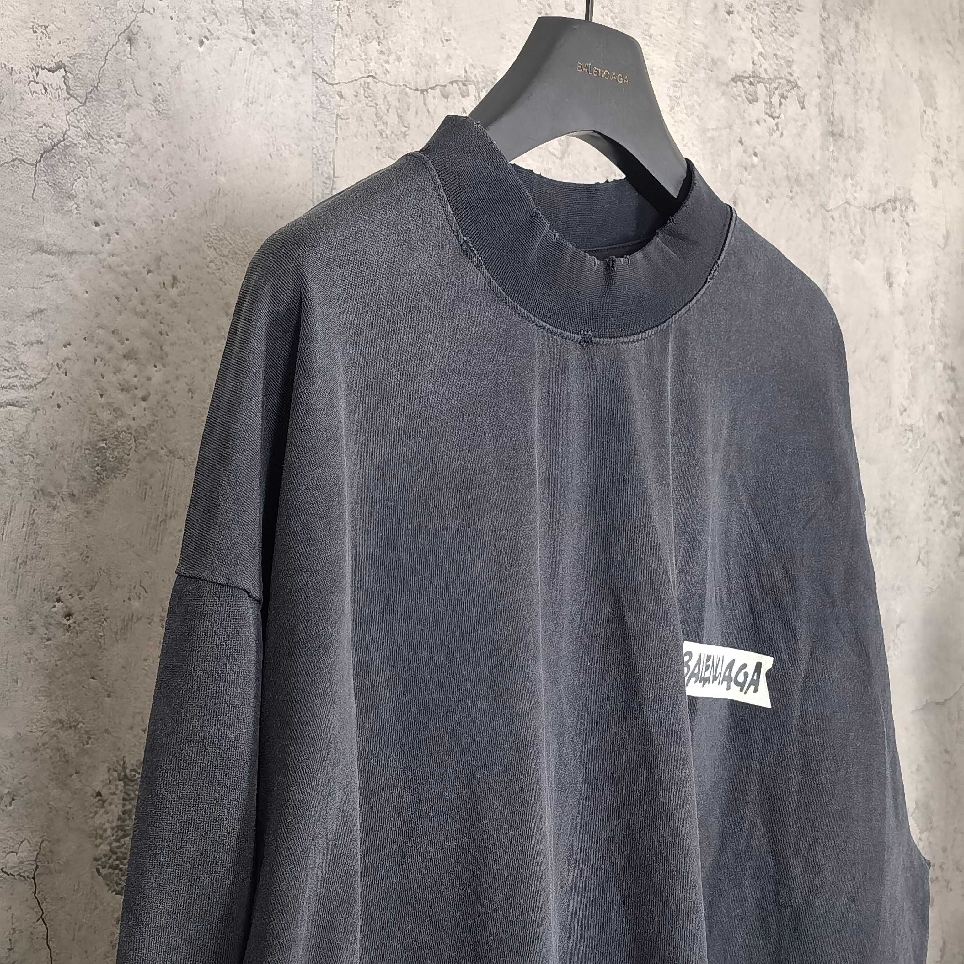 Balenciaga long-sleeve top, dark charcoal gray, crew neck and small side logo