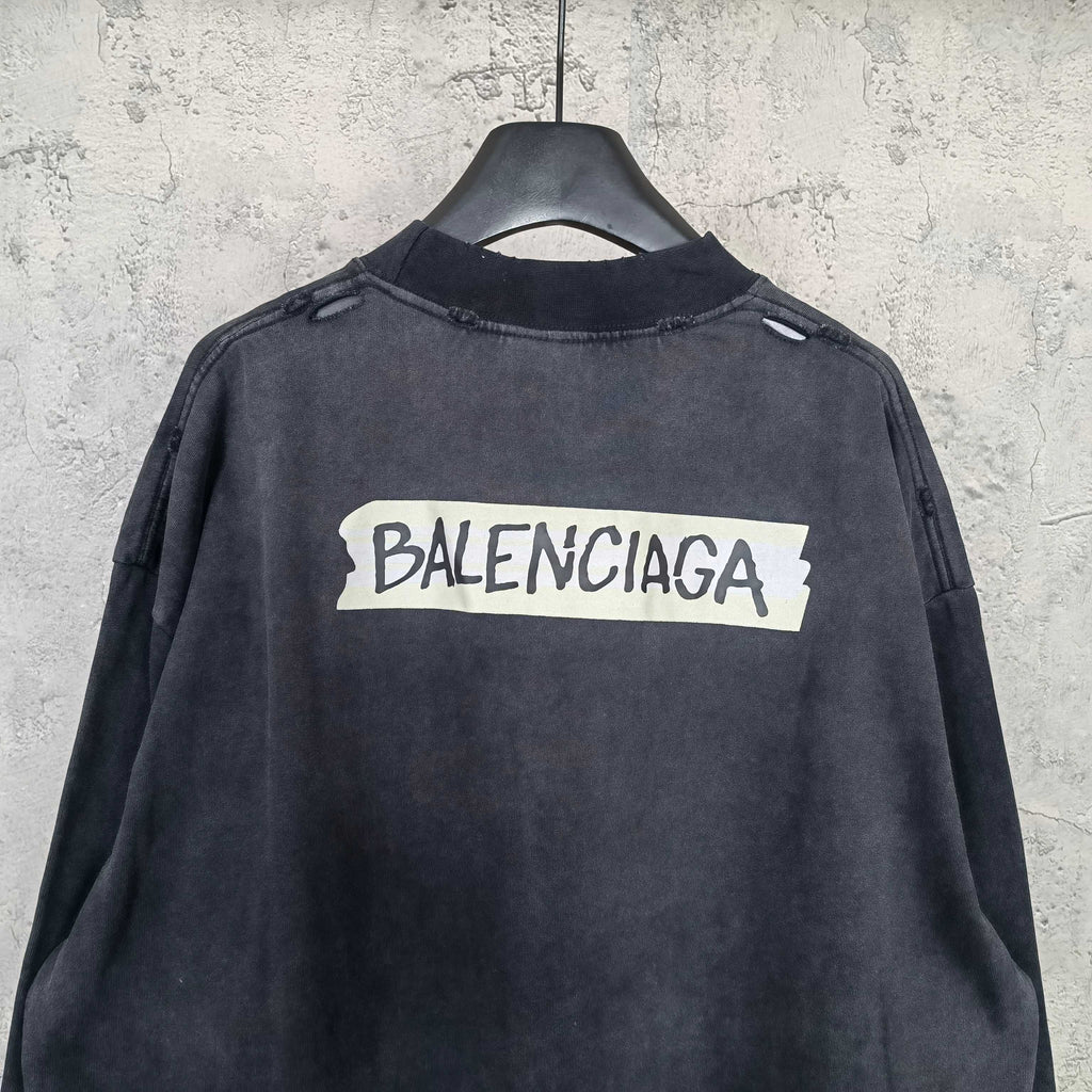 Balenciaga long-sleeve top back view, dark charcoal gray, centered BALENCIAGA logo