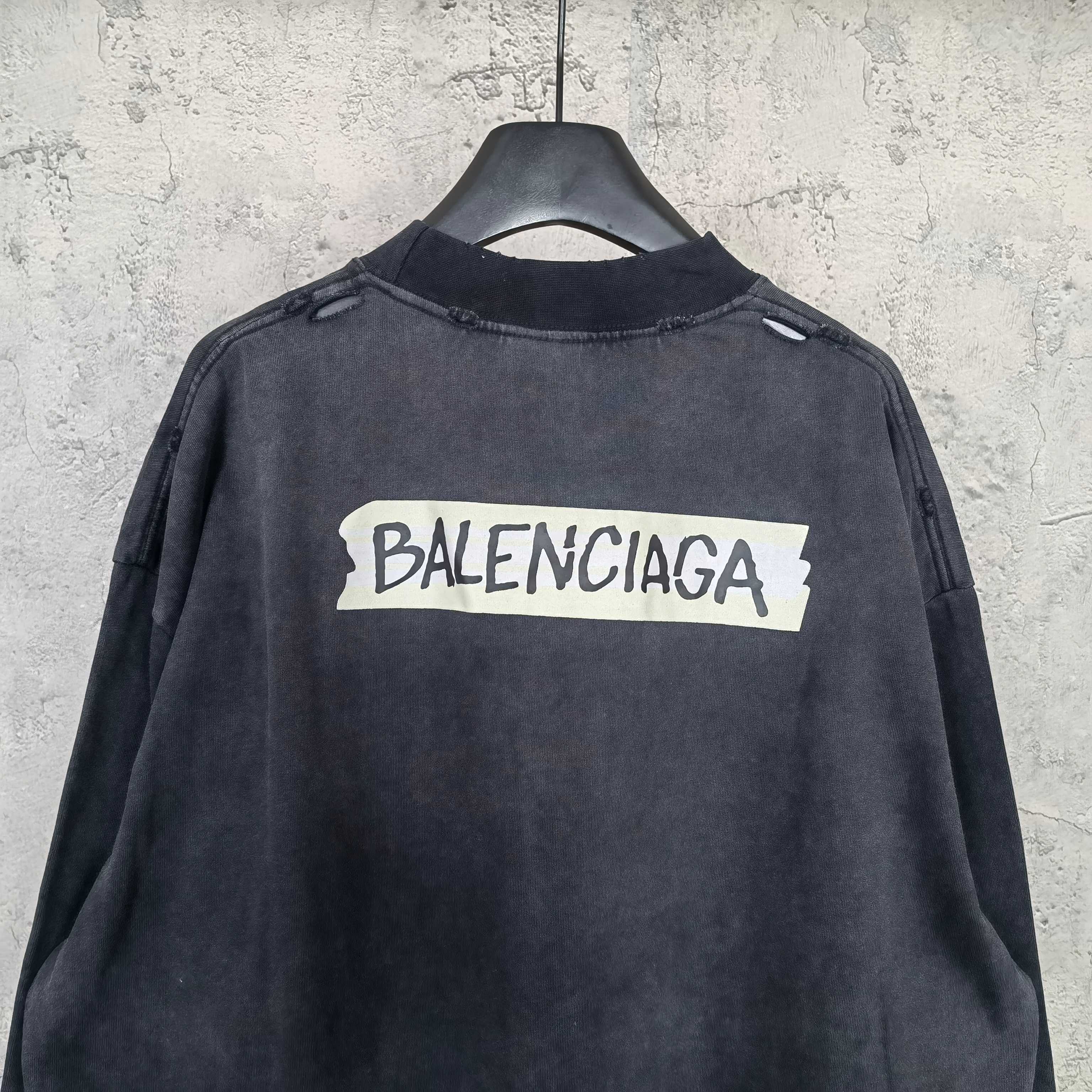 Balenciaga long-sleeve top back view, dark charcoal gray, centered BALENCIAGA logo