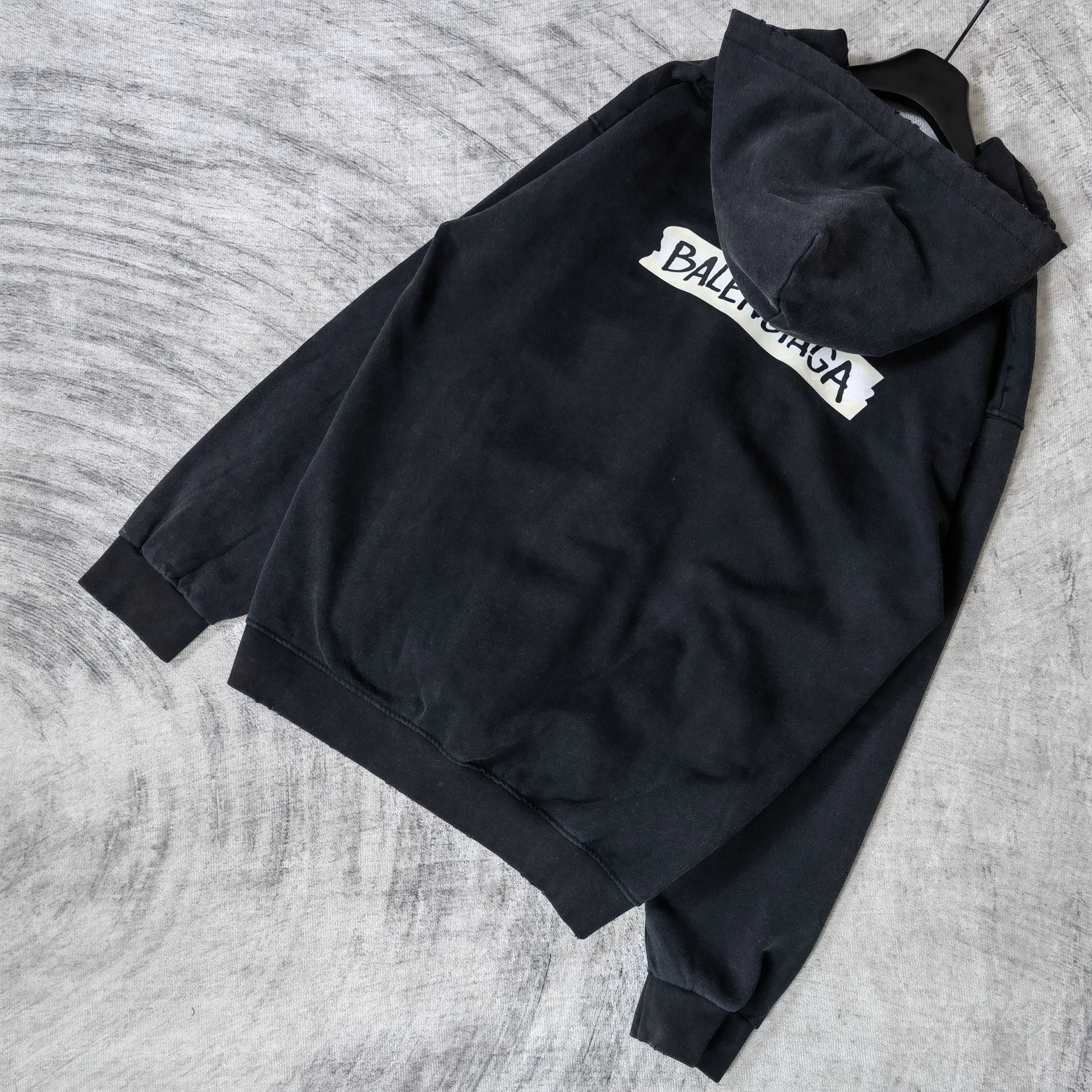 Black zip-up hoodie jacket with hood, back logo patch, and sleeves