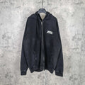 Black zip-up hoodie jacket with hood and chest logo patch