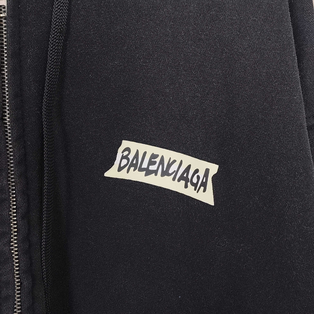Close-up of black hoodie jacket with BALENCIAGA logo on chest