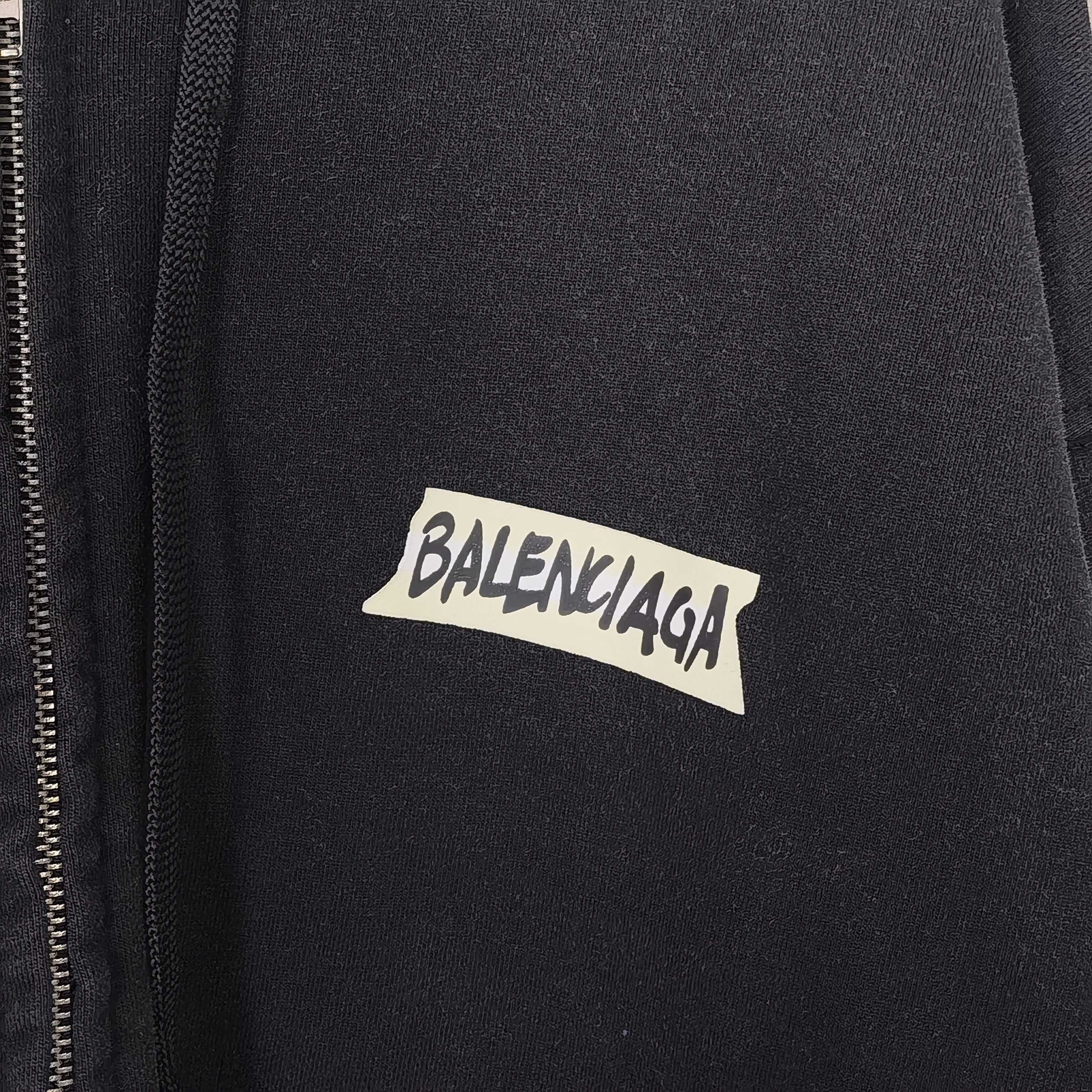 Close-up of black hoodie jacket with BALENCIAGA logo on chest